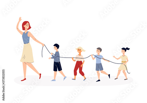 Kindergarten children walking behind teacher with safety rope.