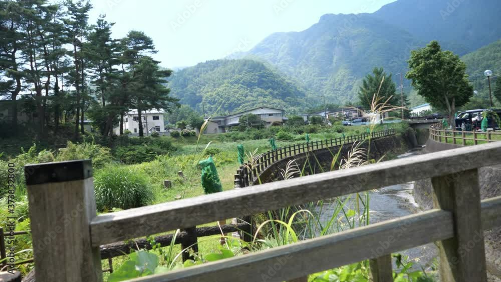 A wooden bridge and mountain scenics in the Japanese countryside A wooden bridge and mountain scenics in the Japanese countryside