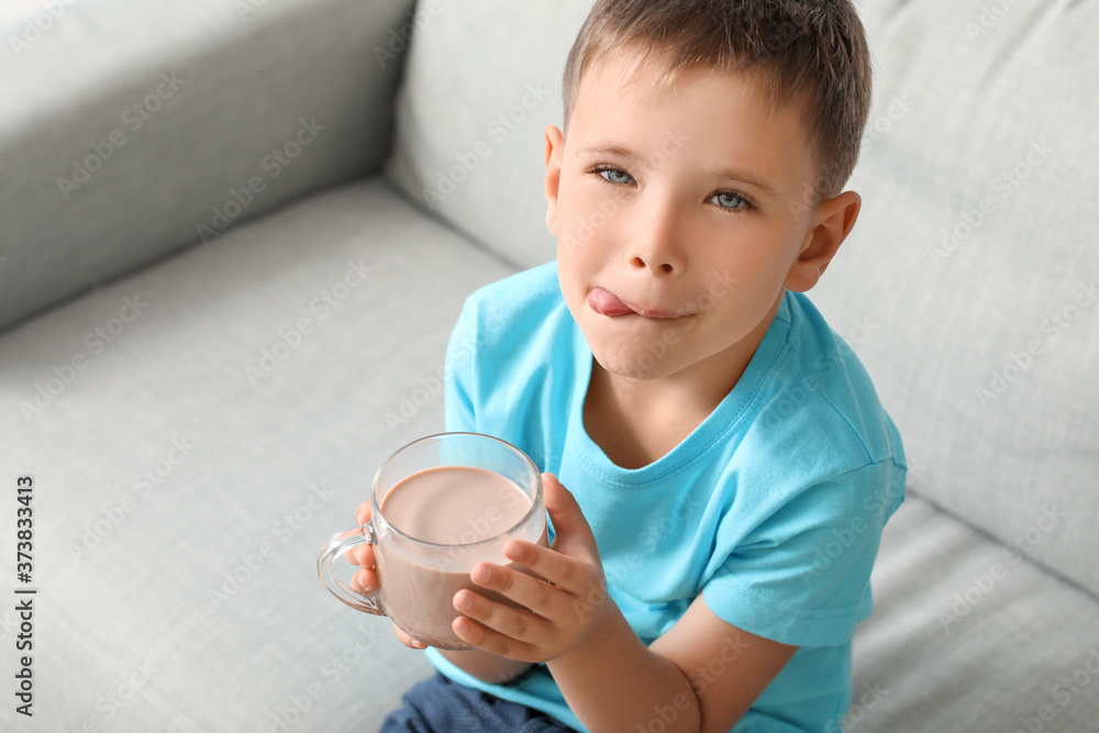 Little boy drinking tasty chocolate milk at home Little boy drinking tasty chocolate milk at home