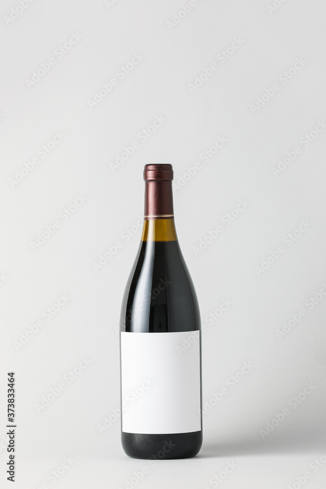 Bottle of wine with blank label on light background. Mockup for design Bottle of wine with blank label on light background. Mockup for design