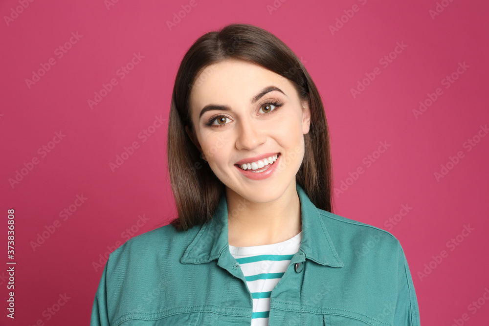 Portrait of happy young woman on pink background Portrait of happy young woman on pink background