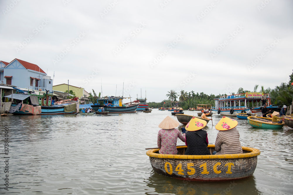 HOI AN,VIETNAM-December 9,2019: Tourists enjoy round basket boat Made of bamboo is a unique Vietnamese at Cam thanh village.
