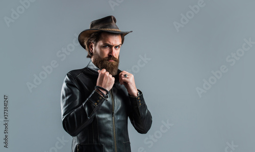Brutal man cowboy hat leather jacket, ranch and farming concept