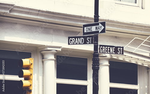 Grand and Greene Street signs in New York City, color toning applied, USA.