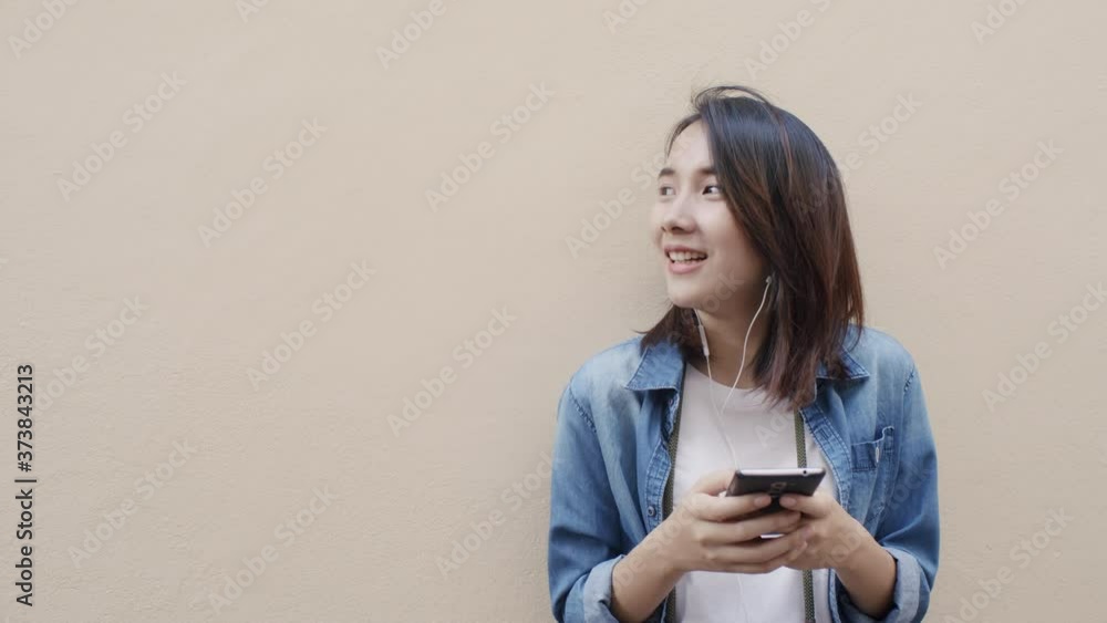 traveler Asian young woman using mobile phone wall outdoor traveler Asian young woman using mobile phone wall outdoor