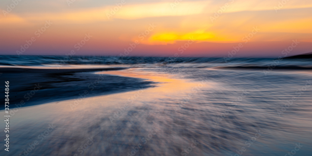 Abstract seascape at sunset. Motion blur with a long exposure.