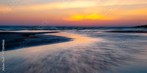 Abstract seascape at sunset. Motion blur with a long exposure.