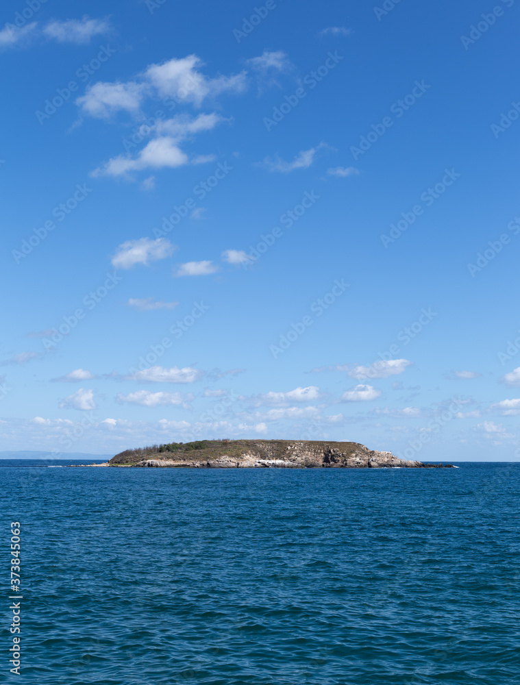 A small uninhabited island in the sea. A small uninhabited island in the sea.