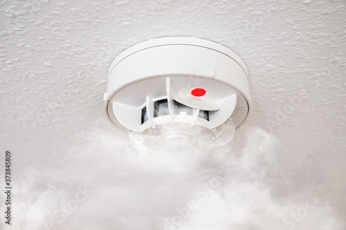 Foto smoke detector or household fire alarm at home