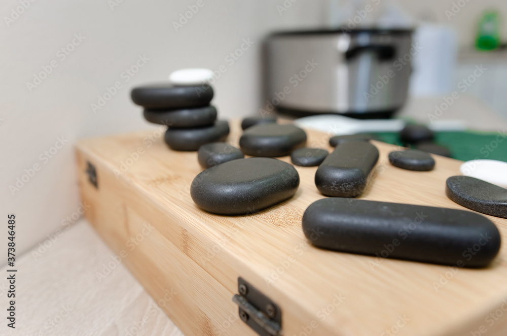 Hot stone massage therapy Close up pile of spa stones with aroma oil still life Hot stone massage therapy Close up pile of spa stones with aroma oil still life