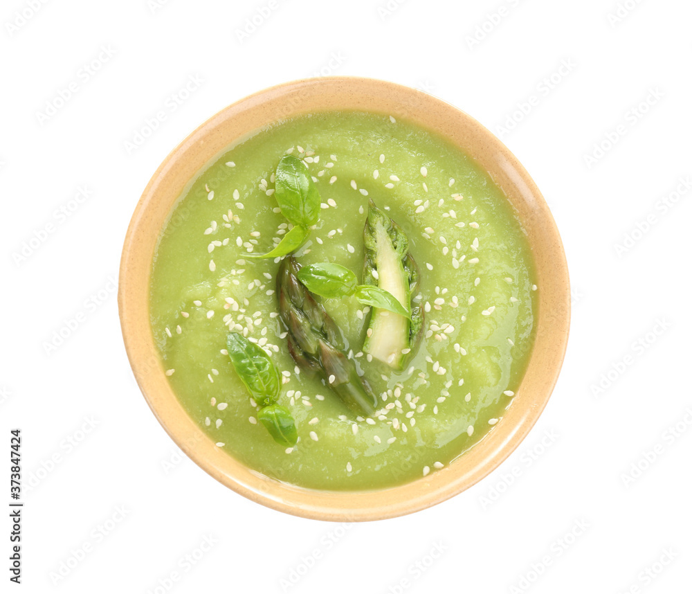 Delicious asparagus soup with basil and sesame seeds isolated on white, top view Delicious asparagus soup with basil and sesame seeds isolated on white, top view