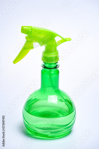 green spray for irrigation of plants on a white background