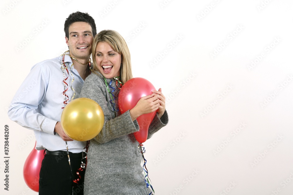 Man and woman with streamers and balloons Man and woman with streamers and balloons