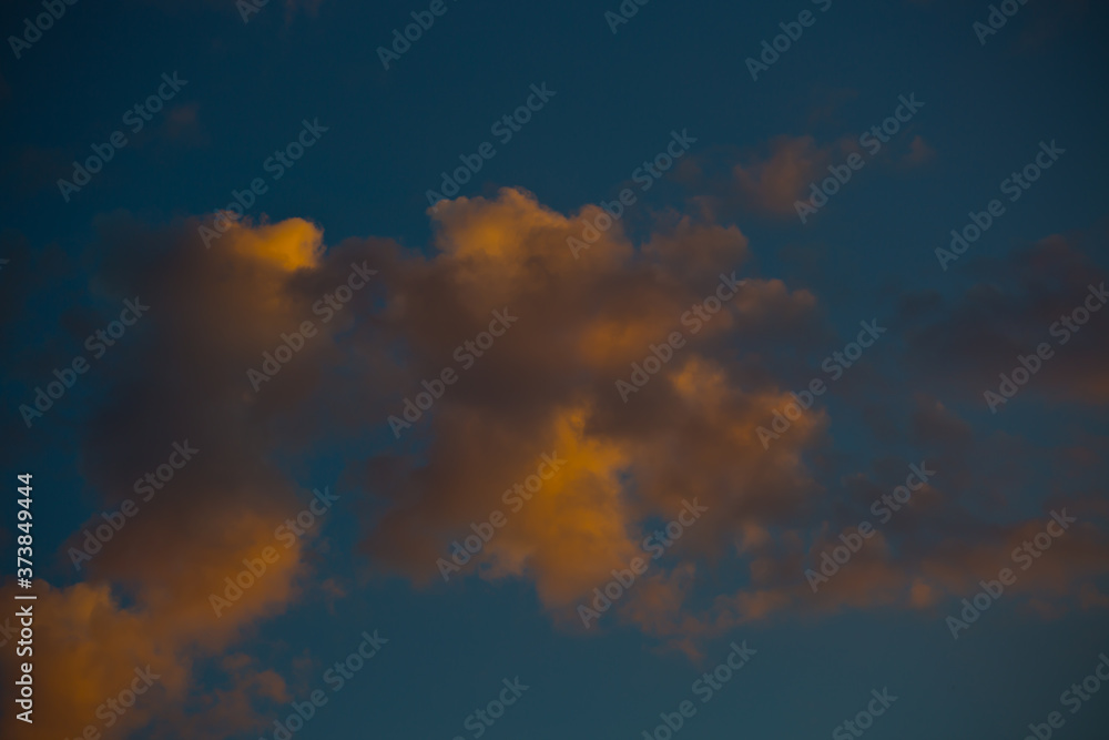 close-up cumulus clouds on the background of the setting sun