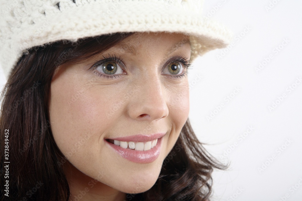 Woman in hat smiling while looking away Woman in hat smiling while looking away
