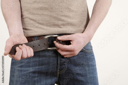 Man adjusting his belt