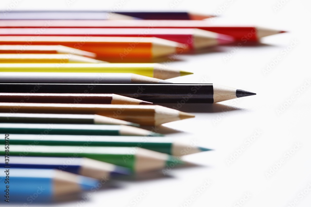 Coloured pencils arranged in a row Coloured pencils arranged in a row