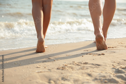 Young couple walking together on beach, closeup