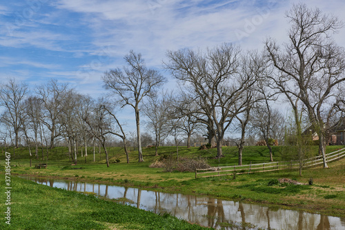 A water full Creek runs lazily through a Sub division at Richmond Texas, between the Community properties and Yards.