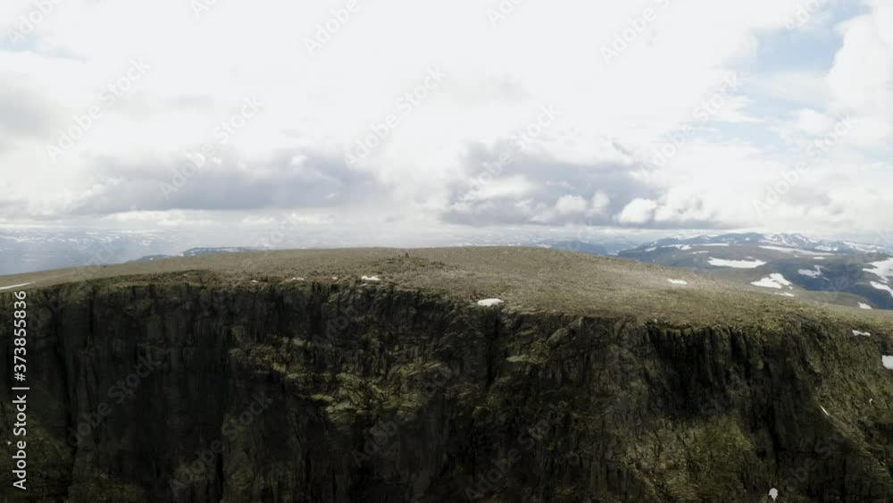 Stunning View Of The Ranastongi Peak In Buskerud, Norway On A Sunny Winter Day - drone pullback shot Stunning View Of The Ranastongi Peak In Buskerud, Norway On A Sunny Winter Day - drone pullback shot