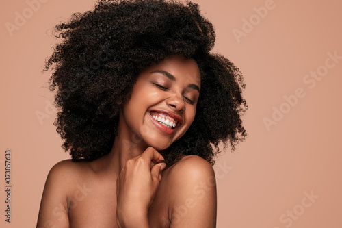 Optimistic black lady with perfect skin