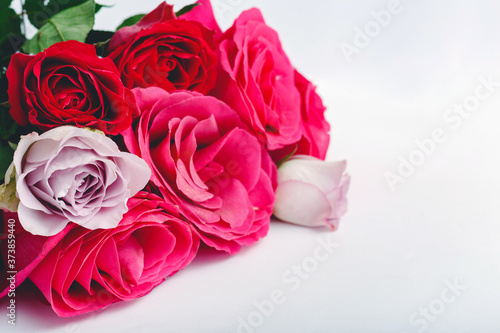 Colorful floral Bouquet of red flowers roses on white background with copy space. Spring festive flowers for Mothers Day, Valentine Day, birthday concept, Hello spring.