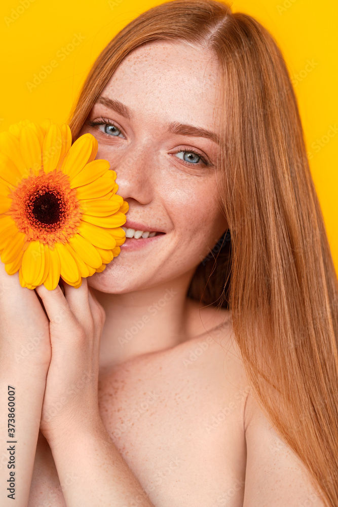 Happy young female enjoying flower softness Happy young female enjoying flower softness