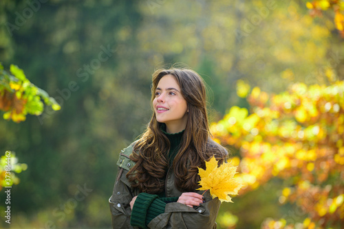 Beautiful girl in stylish fashion clothes in autumn Park. Beautiful woman outdoors in sunny day.