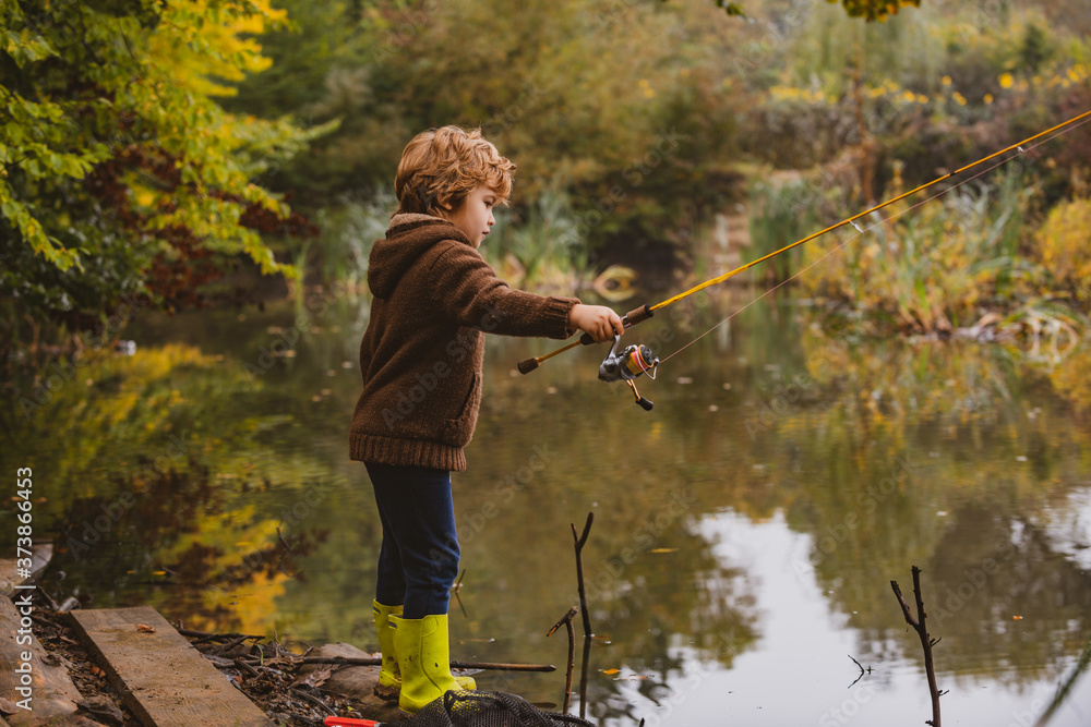 Kid with fishing-rod. Child fishing at autumn lake. Kid with fishing-rod. Child fishing at autumn lake.