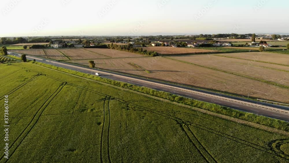 Aerial view of the highway, surrounded by agricultural fields and orchards, located in northern Italy, near Verona. Aerial view of the highway, surrounded by agricultural fields and orchards, located in northern Italy, near Verona.