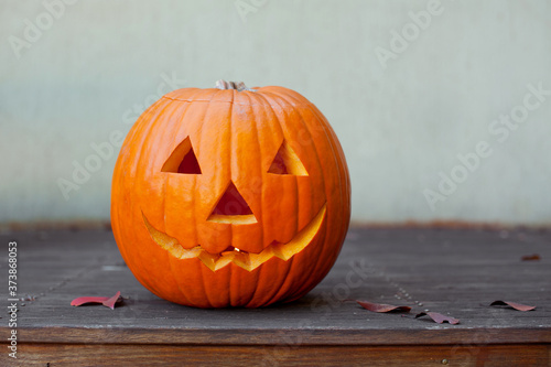 Halloween pumpkin head jack lantern on wooden background