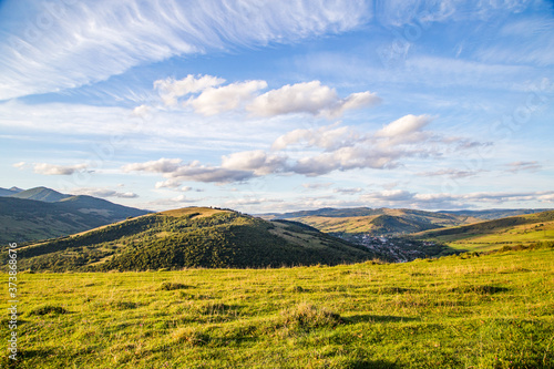 glade on a background of mountain tops and blue sky with clouds. beautiful panorama © robertuzhbt89