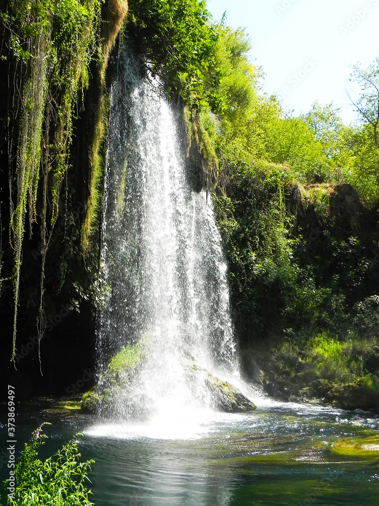 Nature landscape of waterfall in Antalya. Waterfall in mountain forest under the great sky. Adventures and travel concept. Scenic landscape. Beautiful place. Wild nature. Nature landscape of waterfall in Antalya. Waterfall in mountain forest under the great sky. Adventures and travel concept. Scenic landscape. Beautiful place. Wild nature.