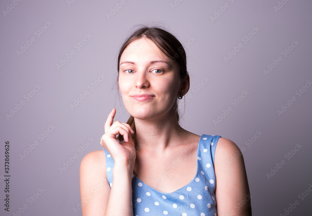 young girl in a blue dress with a pony tail in studio young girl in a blue dress with a pony tail in studio