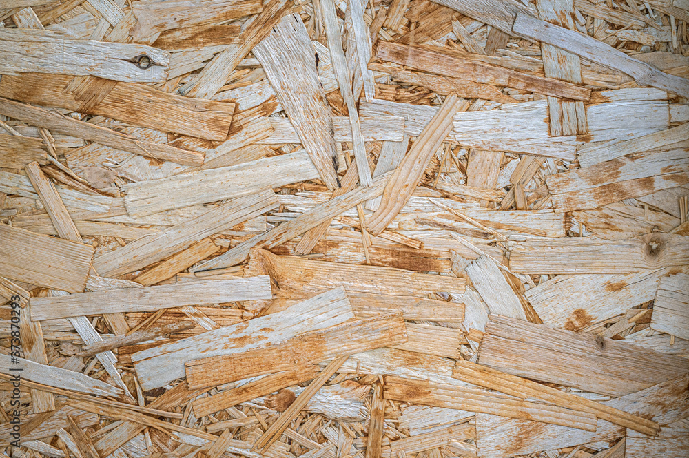 Pressed wood chip board texture. Background of wood chips. Stock Photo