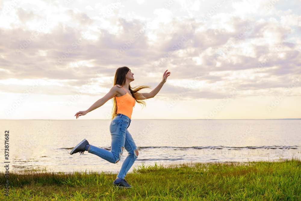 girl posing at dawn against the blue sky on a sunny day girl posing at dawn against the blue sky on a sunny day