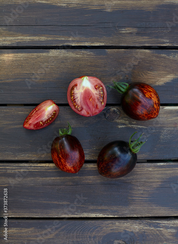 assortment of tomatoes on brown wooden surface photo