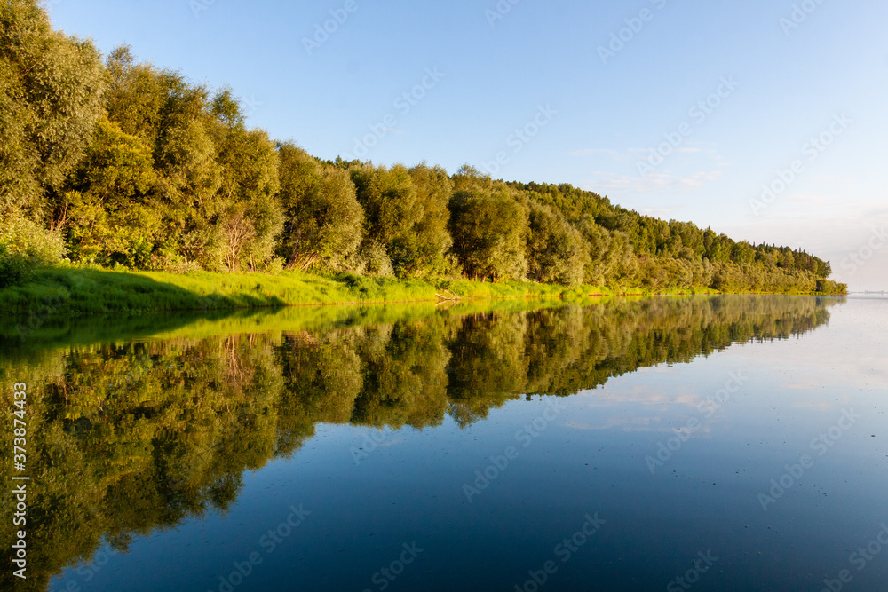 Siberian River Ob surrounded by Trees in Early morning in Russia in sunny weather during summer

