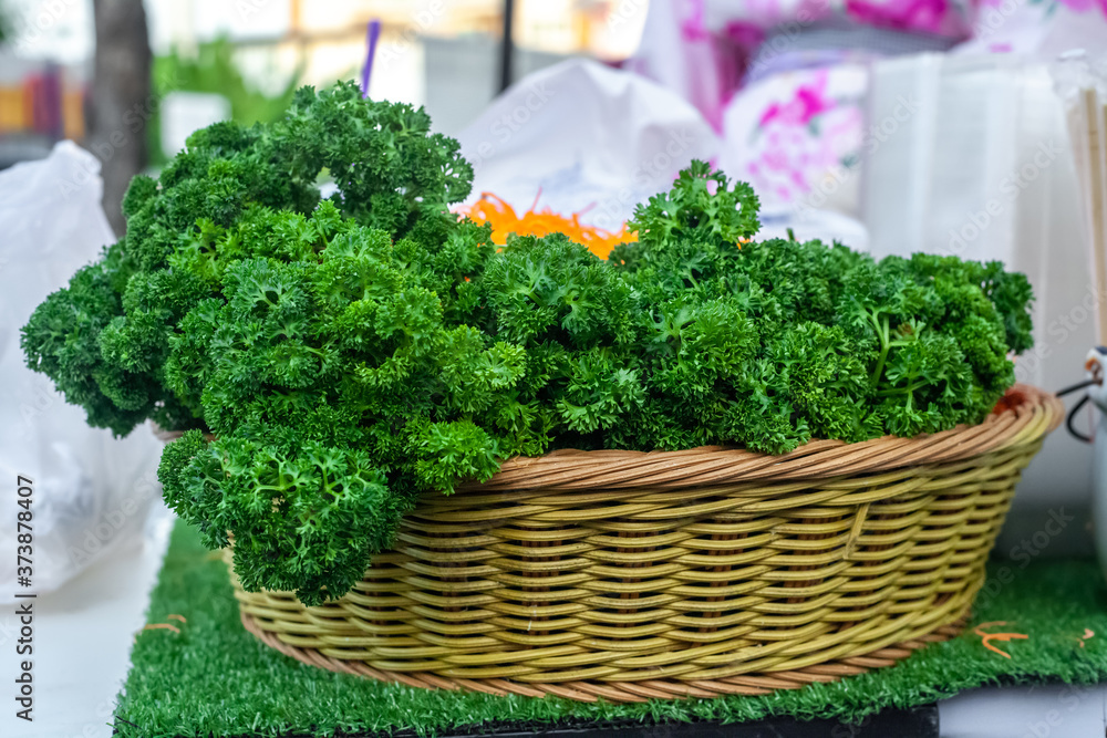 Green parsley in wicker basket Green parsley in wicker basket
