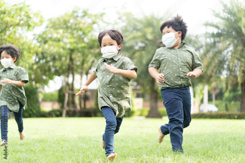 3 brothers are running and playing in the garden.
