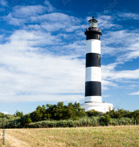 Lighthouse with blue sky and summer clouds in chassiron, Oleron Island, France