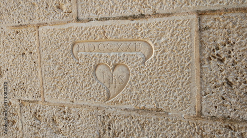 A sign on the wall in Perast, Montenegro photo