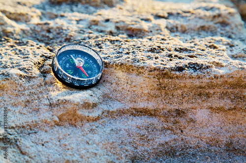 Compass on rock, copy space. Vacation travel or Travelling around world. Summer time. Backpacking. Travel destinations. 