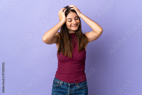 Young caucasian woman isolated on purple background laughing