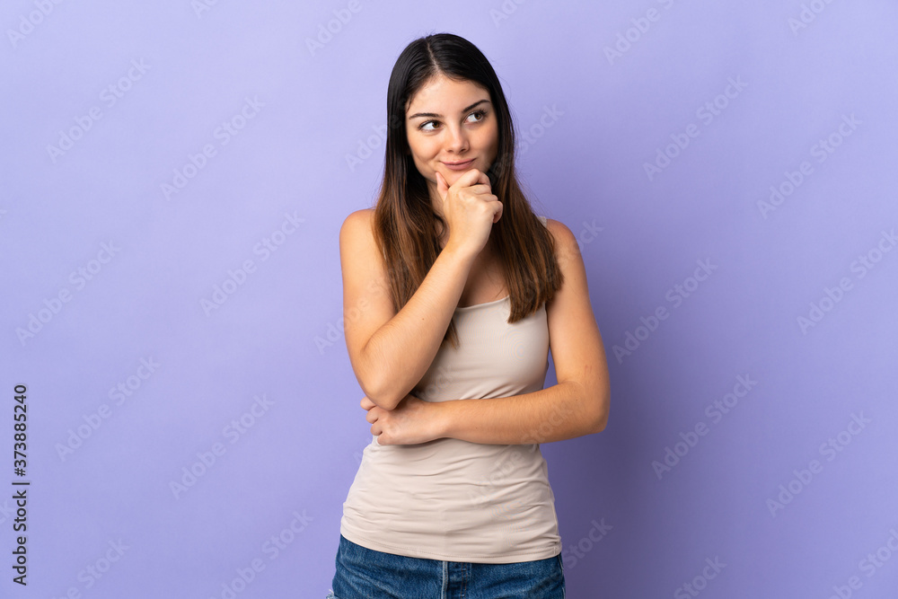 Young caucasian woman isolated on purple background thinking an idea while looking up Young caucasian woman isolated on purple background thinking an idea while looking up