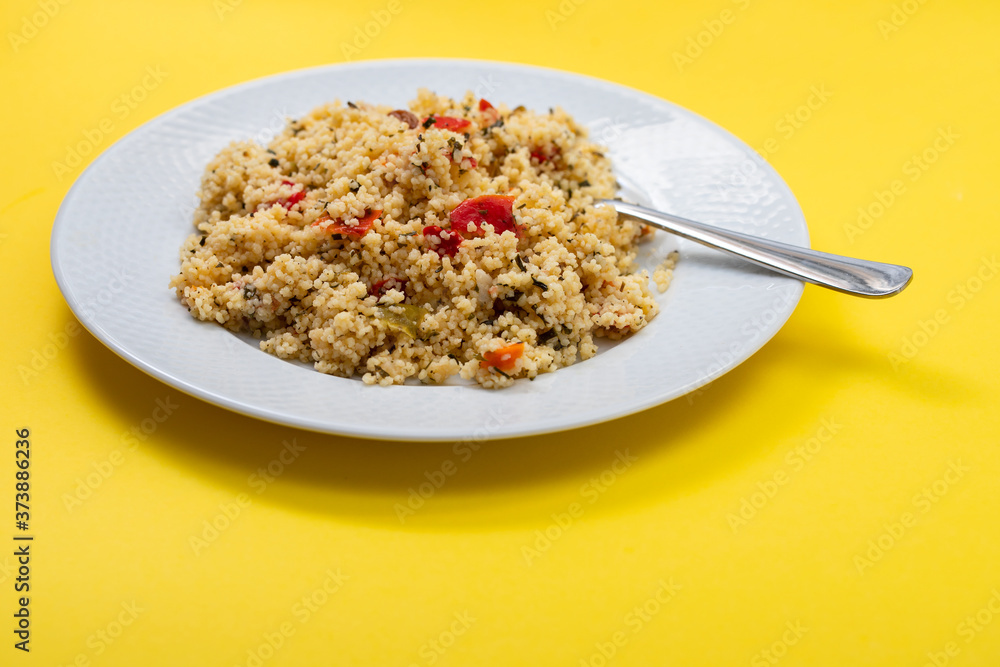 fresh vegetable salad with couscous on white plate fresh vegetable salad with couscous on white plate