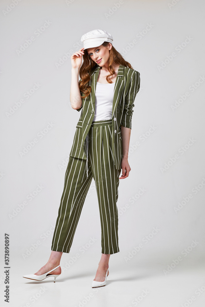 Fashion portrait of young elegant woman in trendy suit. Fashion portrait of young elegant woman in trendy suit.