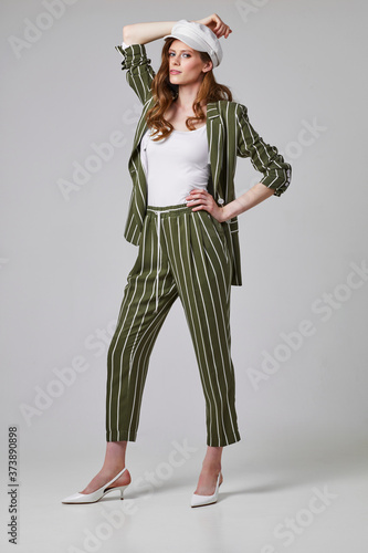 Fashion portrait of young elegant woman in trendy suit.