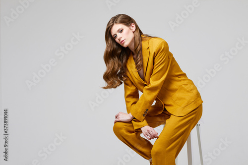 Fashion portrait of young elegant woman in trendy linen suit.