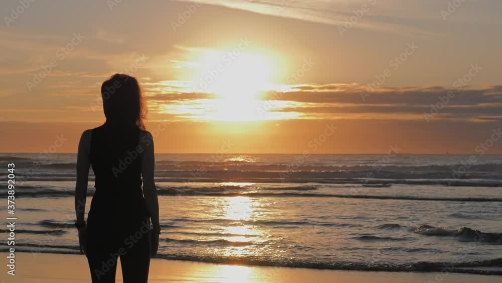 Silhouette of woman with arms raised up on beach, Practice of breath techniques Silhouette of woman with arms raised up on beach, Practice of breath techniques